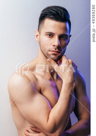 Thoughtful shirtless man portrait posing in studio Thoughtful shirtless man portrait posing in studio 49369280