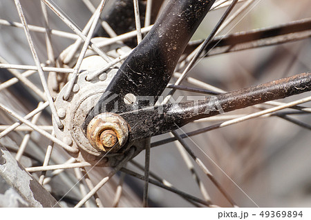 Details of the center of the bicycle wheel. Skewers, fork and nut in shallow focus. 49369894