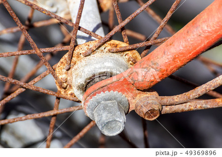 Details of the center of the bicycle wheel. Skewers, fork and nut in shallow focus. 49369896