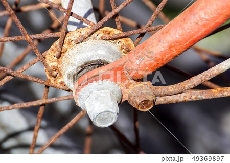 Details of the center of the bicycle wheel. Skewers, fork and nut in shallow focus. 49369897