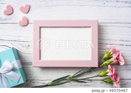 top view of carnation with photo frame on white top view of carnation with photo frame on white 49370467