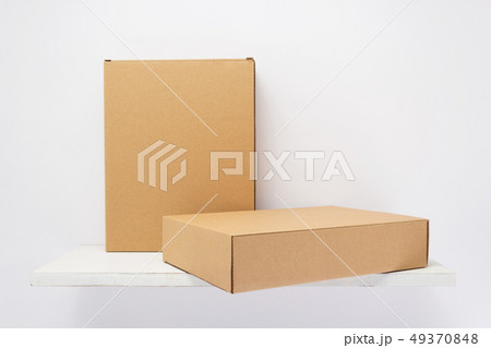 cardboard box on wooden shelf 49370848