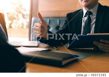 Job interviewer give a thumbs-up for job 49371585