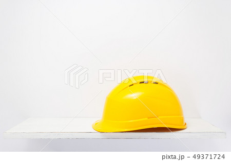 construction helmet on wooden shelf at white construction helmet on wooden shelf at white 49371724