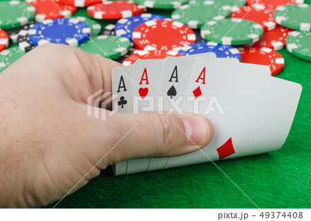 Hand with playing cards in casino 49374408