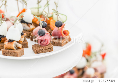 Buffet table. Assortment of canapes. Banquet service in restaurant. Catering food, snacks on white 49375564