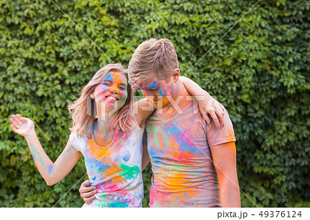 Friendship, festival of holi, people concept - young couple playing with colors at the festival of Friendship, festival of holi, people concept - young couple playing with colors at the festival of 49376124