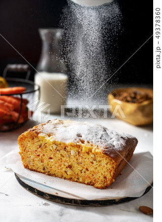 Vertical shot of carrot cake with powdered sugar, 49378360