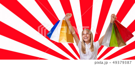 Cheerful girl with shopping bags with raised up 49379387