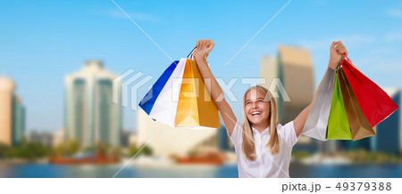 Shopping smiling woman holding shopping bags  49379388