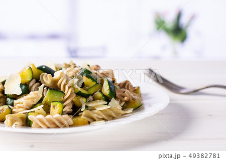 Fusilli pasta with zucchini with red tulips Fusilli pasta with zucchini with red tulips 49382781