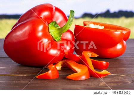Fresh red paprika with field behind Fresh red paprika with field behind 49382939