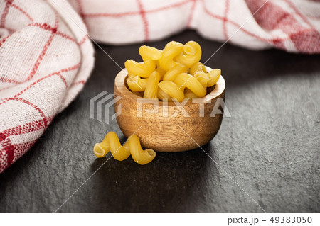 Cavatappi pasta raw on grey stone Cavatappi pasta raw on grey stone 49383050