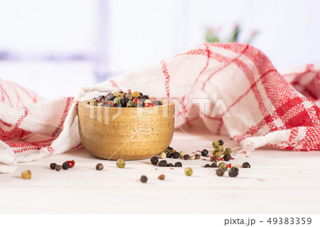 Four colors of peppercorns with red tulips 49383359