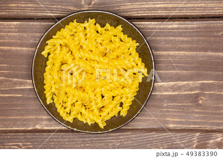 Raw italian torti pasta on brown wood 49383390