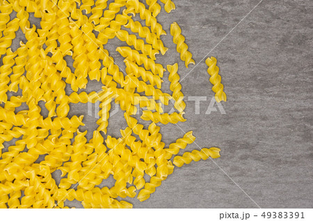Raw italian torti pasta on grey stone Raw italian torti pasta on grey stone 49383391