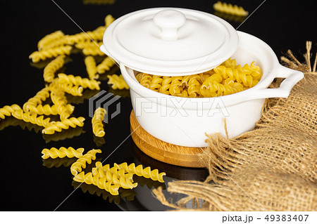 Raw italian torti pasta on black glass 49383407
