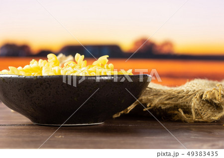 Raw italian torti pasta with autumn field behind 49383435