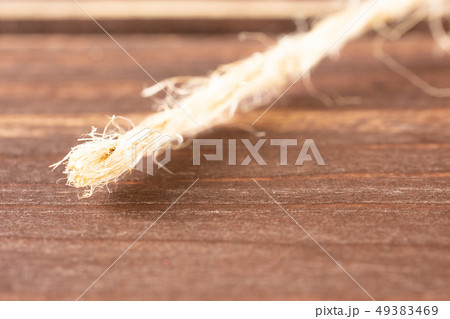 Yellow simple pencil on brown wood 49383469