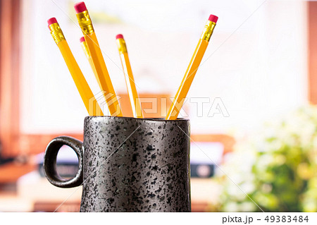 Yellow simple pencil with books on window Yellow simple pencil with books on window 49383484