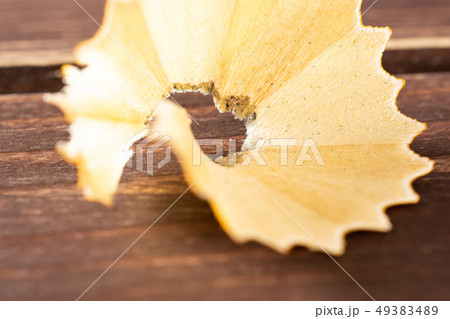 Yellow simple pencil on brown wood 49383489