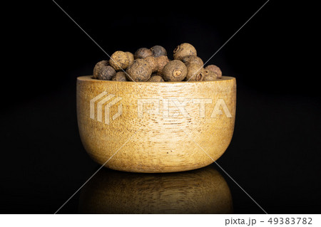 Dry allspice berries isolated on black glass Dry allspice berries isolated on black glass 49383782