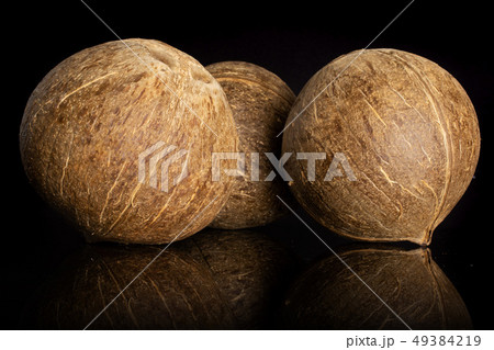 Fresh bio coconut isolated on black glass Fresh bio coconut isolated on black glass 49384219