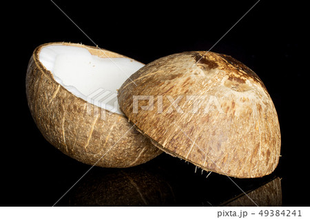 Fresh bio coconut isolated on black glass Fresh bio coconut isolated on black glass 49384241