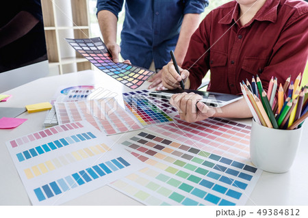 Two colleague creative graphic designer working on 49384812