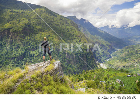 Man standing on hill top in Himalayas 49386930