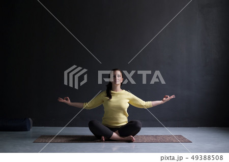 Young woman practicing yoga, sitting on meditation Young woman practicing yoga, sitting on meditation 49388508