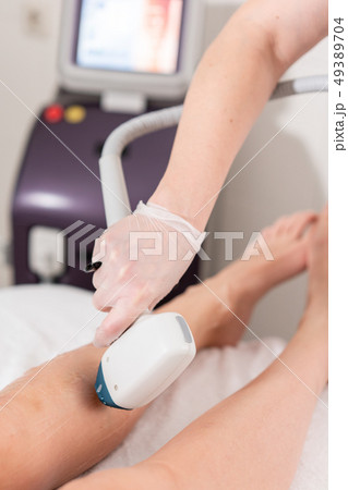 Laser epilation and cosmetology. Hair removal on ladies legs. at cosmetic beauty spa clinic 49389704