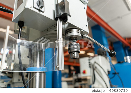 Drilling machine. New Industrial Iron drill in workshop interior. Tool store or exposition stand. Drilling machine. New Industrial Iron drill in workshop interior. Tool store or exposition stand. 49389739