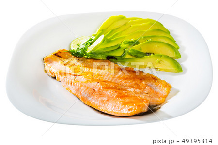 Fried trout fillet served with avocado is tasty dish Fried trout fillet served with avocado is tasty dish 49395314