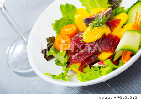 Tuna salad with vegetables and fruits 49395929