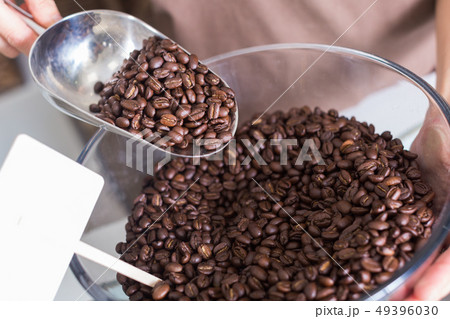 Seller is pouring coffee from glass container Seller is pouring coffee from glass container 49396030