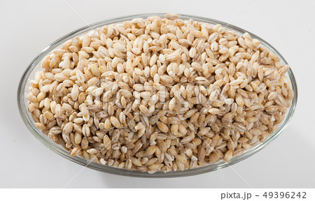 Barley groats in glass bowl on white surface , nobody Barley groats in glass bowl on white surface , nobody 49396242