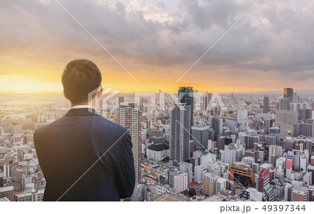 Businessman in blue suit and Osaka city sunset 49397344