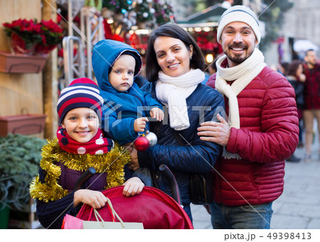 Happy family with children at Christmas market Happy family with children at Christmas market 49398413