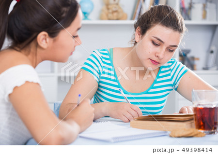 Teenagers girls studying at home Teenagers girls studying at home 49398414
