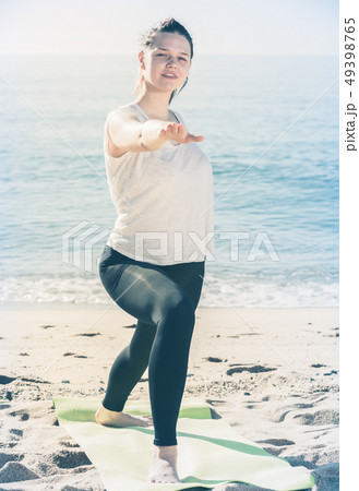 Female in white T-shirt is stretching Female in white T-shirt is stretching 49398765
