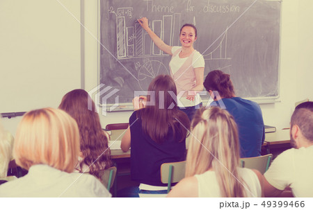 Student girl standing at blackboard Student girl standing at blackboard 49399466