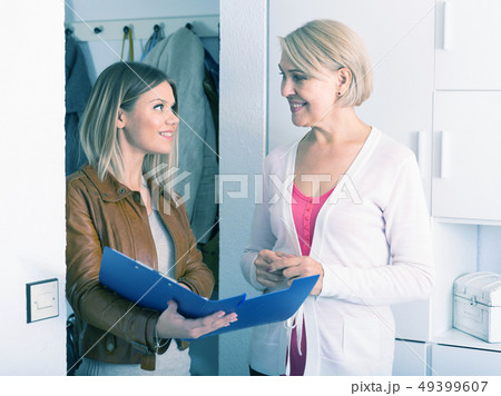 daughter shows some documents of her mother 49399607