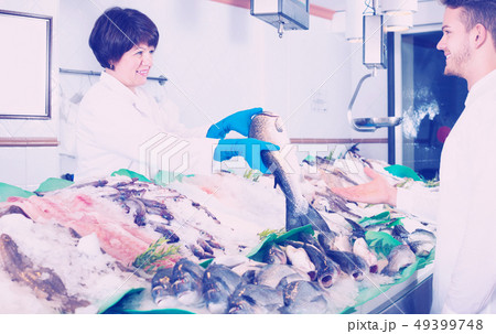 Customer choosing and buying fish 49399748
