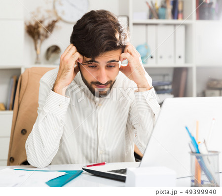 Office worker trying to solve difficult problem Office worker trying to solve difficult problem 49399940