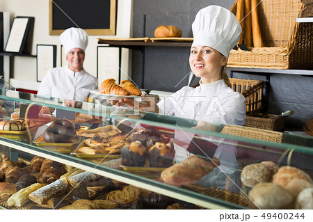 Laughing women with desserts in the pastry shop 49400244