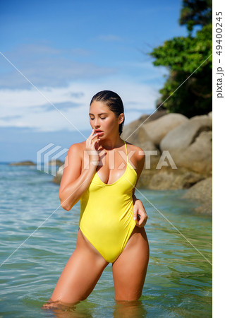Beautiful girl posing on the beach in the hot sun 49400245