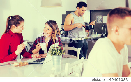 Female travelers planning itinerary in hostel kitchen Female travelers planning itinerary in hostel kitchen 49401088