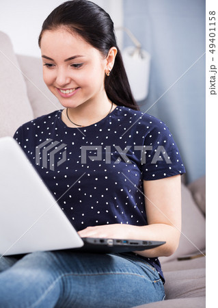 Young woman with laptop on sofa Young woman with laptop on sofa 49401158