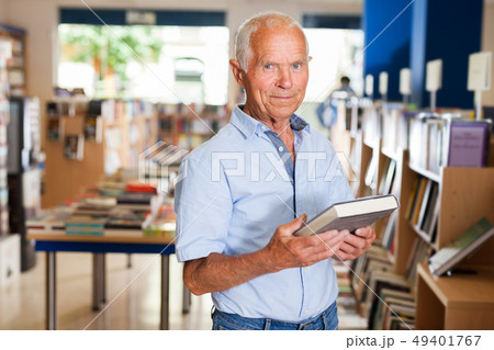 Happy elderly man in bookstore Happy elderly man in bookstore 49401767